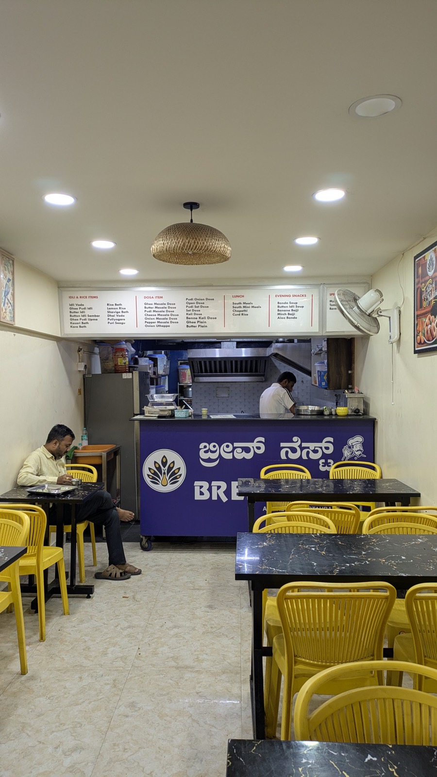 Bright interior with yellow chairs at Brew Nest, a pure veg restaurant in Koramangala